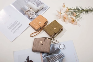 Three quilted PU leather wallets in orange, olive green, and taupe with wrist straps
