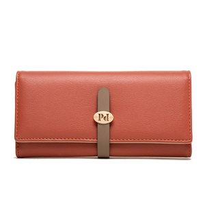 Macro view of brick orange lychee grain leather texture and golden metal Pd logo detail
