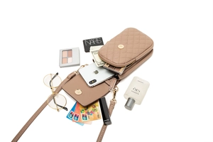 Interior detail of quilted crossbody phone bag showing high storage capacity for essentials