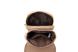 Detail view of the interior dual compartments and lining of the beige quilted phone bag