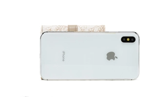 Floral print short trifold wallet for women shown with a smartphone for size reference