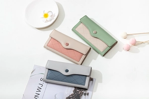 Detail of color-block long wallets with rose clasp and elegant diamond quilted texture