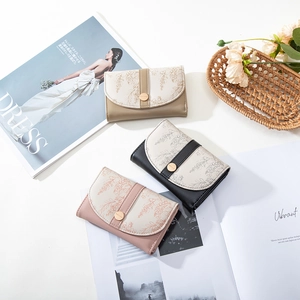 Flat lay of colorful floral print PU leather wallets with elegant circular metal clasps