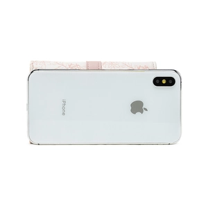 Close-up of pink floral PU leather wallet with snap button next to an iPhone for size comparison