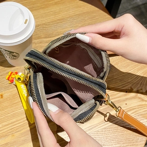 Multi-compartment crossbody phone bag in dark grey fabric with brown leather trim