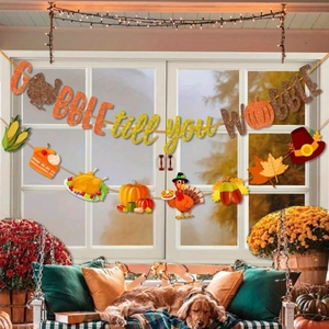 Thanksgiving party banner featuring Gobble till you Wobble letters and fall themed icons