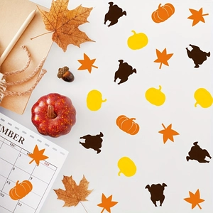 Thanksgiving party confetti with maple leaves, pumpkins and turkeys for table decor