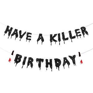 Detail of glittery black 'HAVE A KILLER BIRTHDAY' banner with bloody knife accents