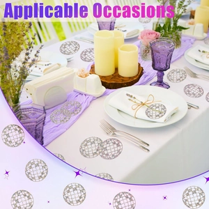 Close-up of silver laser disco ball confetti decorations on a festive dinner table