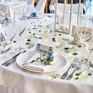 Sage green and gold Happy Birthday confetti set scattered on a white party table