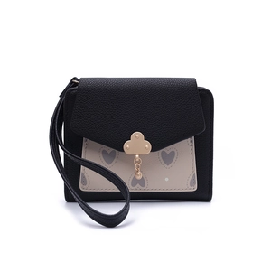 Close-up of heart pattern on beige flap with golden cloud lock on a short wallet