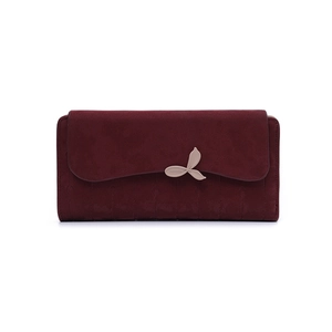 Detail of burgundy long wallet featuring leaf-shaped clasp and leaf vein stitching