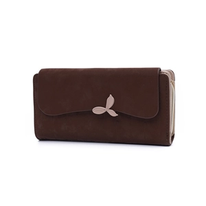 Detailed macro view of the accordion-style gusset and metal leaf clasp on a coffee wallet
