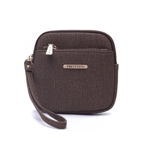 Detail of dark brown textured fabric wallet with gold logo and matching wrist strap