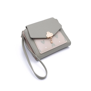 Detail of green litchi leather wallet with cloud clasp, pearl charm and heart pattern