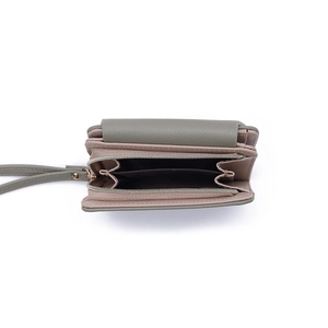 Dual zipper compartments of compact faux leather wallet showing gray-green and pink interior