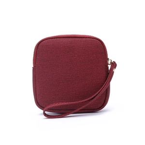 Detailed close-up of dark red square coin purse featuring woven texture and wrist strap