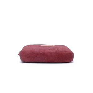 Detail view of deep red pebble leather women's wallet with elegant gold logo plaque