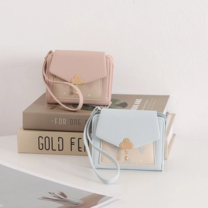 Detailed view of PU leather wallets with cloud pendants and heart patterns