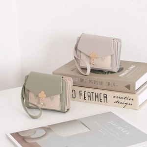 Detail of short PU leather wallets featuring cloud pendants and heart print patterns