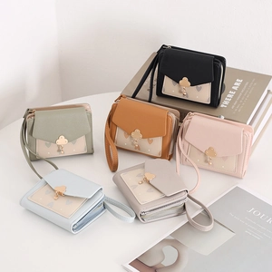 Short faux leather women's wallets with heart patchwork and clover buckle in six colors