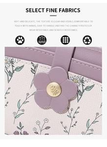 Detail of floral PU leather wallet with daisy prints and a gold leaf-shaped buckle