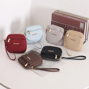 Close-up of stylish mini wallets showing vertical fabric texture and gold hardware
