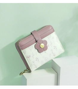 Detail of PU leather wallet with flower clasp, golden leaf zipper and floral pattern