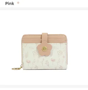 Detail of pink floral PU leather wallet featuring flower snap button and heart zipper pull
