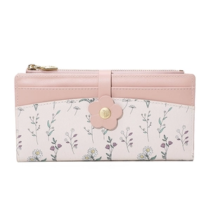 Detail of pink PU leather wallet with floral print and decorative flower buckle