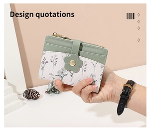 Detail of compact floral card holder with green leather accents and golden zipper