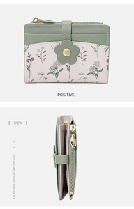 Detail of floral women's small wallet showing side profile and elegant leaf-shaped zipper pull