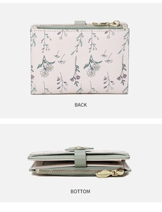 Detail of floral PU leather wallet featuring gold leaf zipper and daisy print patterns