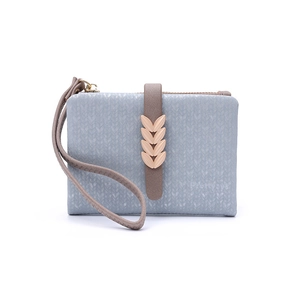 Close-up of light blue wallet featuring leaf metal buckle and zip closure details