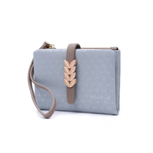 Close-up of blue-grey wallet with gold wheat buckle and textured floral pattern