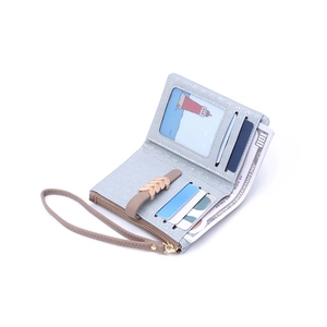 Light blue pebbled leather bifold wallet with wristlet, interior slots and zip pocket