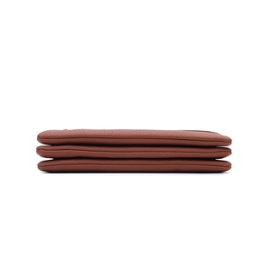 Close-up of brown litchi pattern leather wallet showing three-layer accordion structure