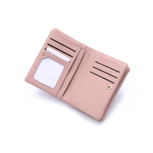 Interior detail of pink leather bifold wallet showing card slots and snap closure