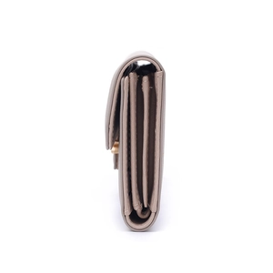 Detailed side view of beige PU leather long wallet showing accordion compartments