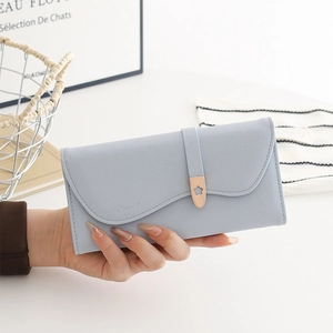 Macro detail of the light blue cross-grain faux leather wallet and flower buckle