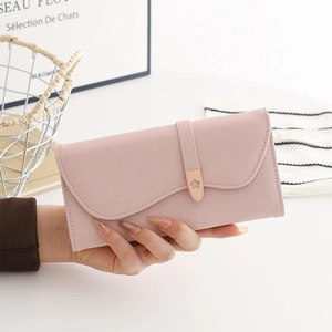 Detail of soft pink PU leather wallet with litchi texture and elegant wavy edge design