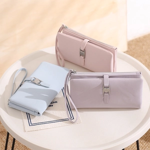Three long PU leather wallets in pink, blue, and purple with heart metal clasps and wristlets