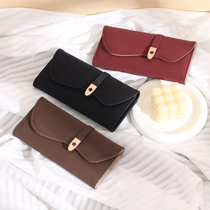 Three leather purses in wine red, black and coffee with floral buckle on white satin