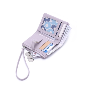 Short lavender fold wallet with wristlet, multi-card slots and coin pocket on white background