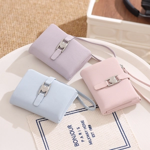 Detailed close-up of macaron-colored PU leather wallets with heart buckles and wrist straps