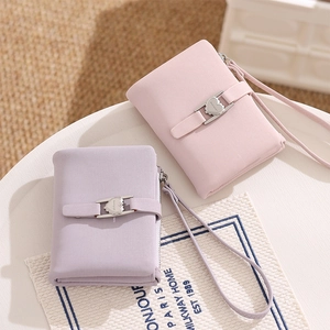 Detail of pink and purple PU leather wallets with heart buckle and wristlet straps