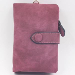 Detailed view of burgundy frosted matte wallet with snap closure and vintage round buckle