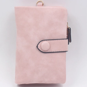 Detail view of light pink frosted matte wallet showing snap closure and fine texture