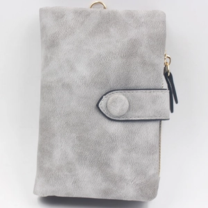 Close-up of gray frosted trifold wallet showing snap closure and gold side zipper detail