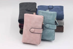 Detailed pileup of frosted suede wallets in various colors featuring metal top rings